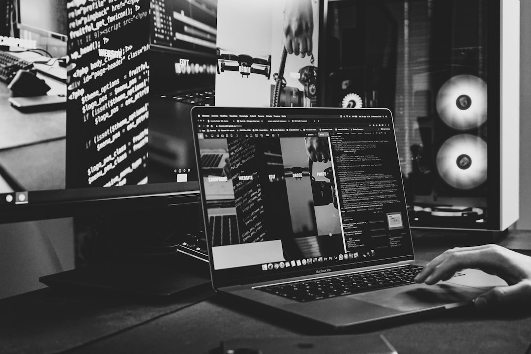 Person working on laptop with code on screen